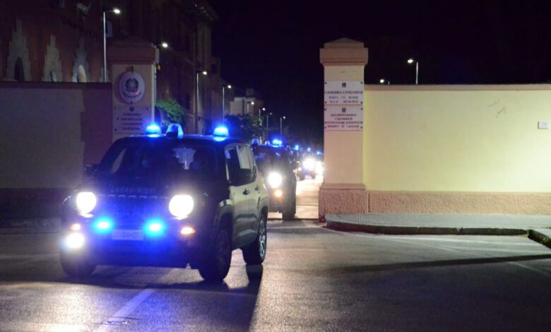Auto dei Carabinieri con i lampeggianti accesi escono di notte dalla caserma a Cagliari